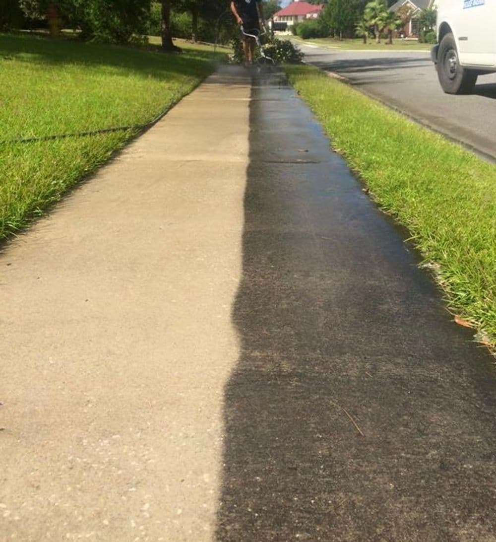 Before and after pressure washing sidewalk, showcasing clean concrete transformation.