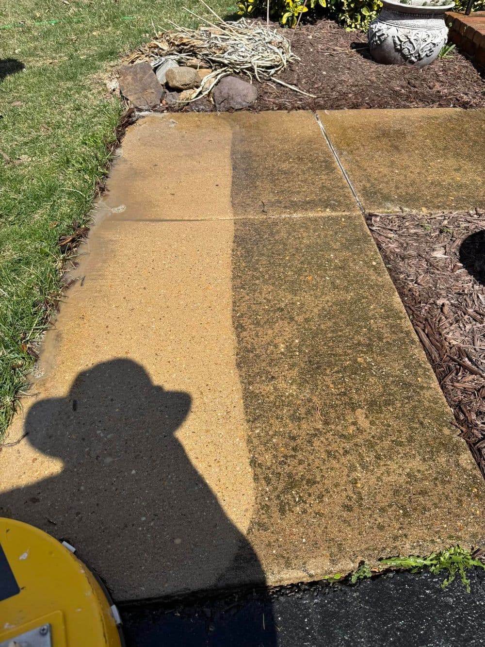 Before and after concrete cleaning showing clear contrast between clean and dirty surfaces.